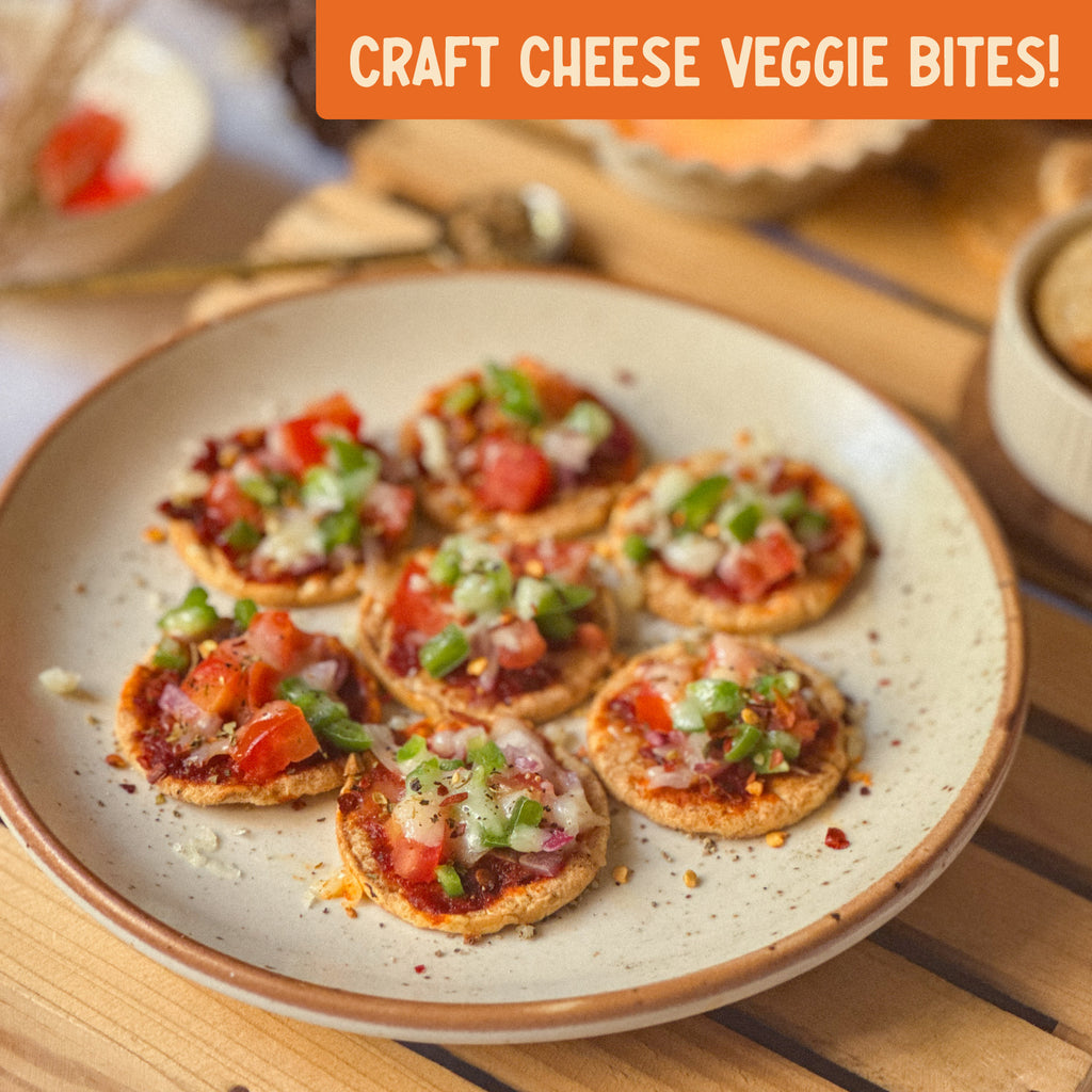Plate of craft cheese veggie bites on a wooden table with an orange banner at the top.